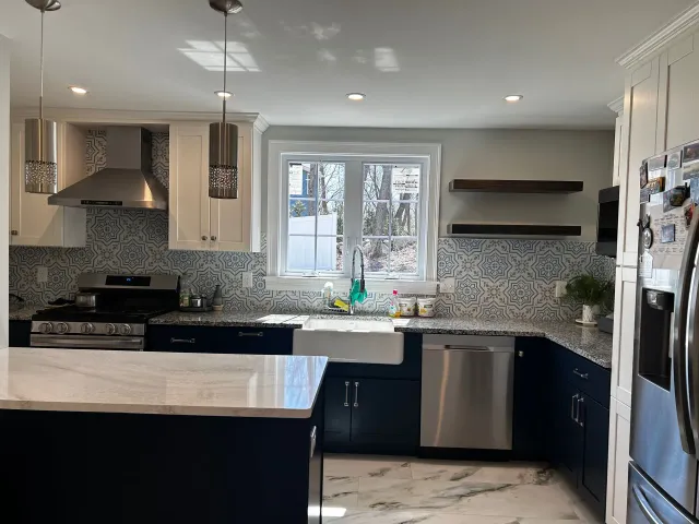 A kitchen with stainless steel appliances and blue cabinets