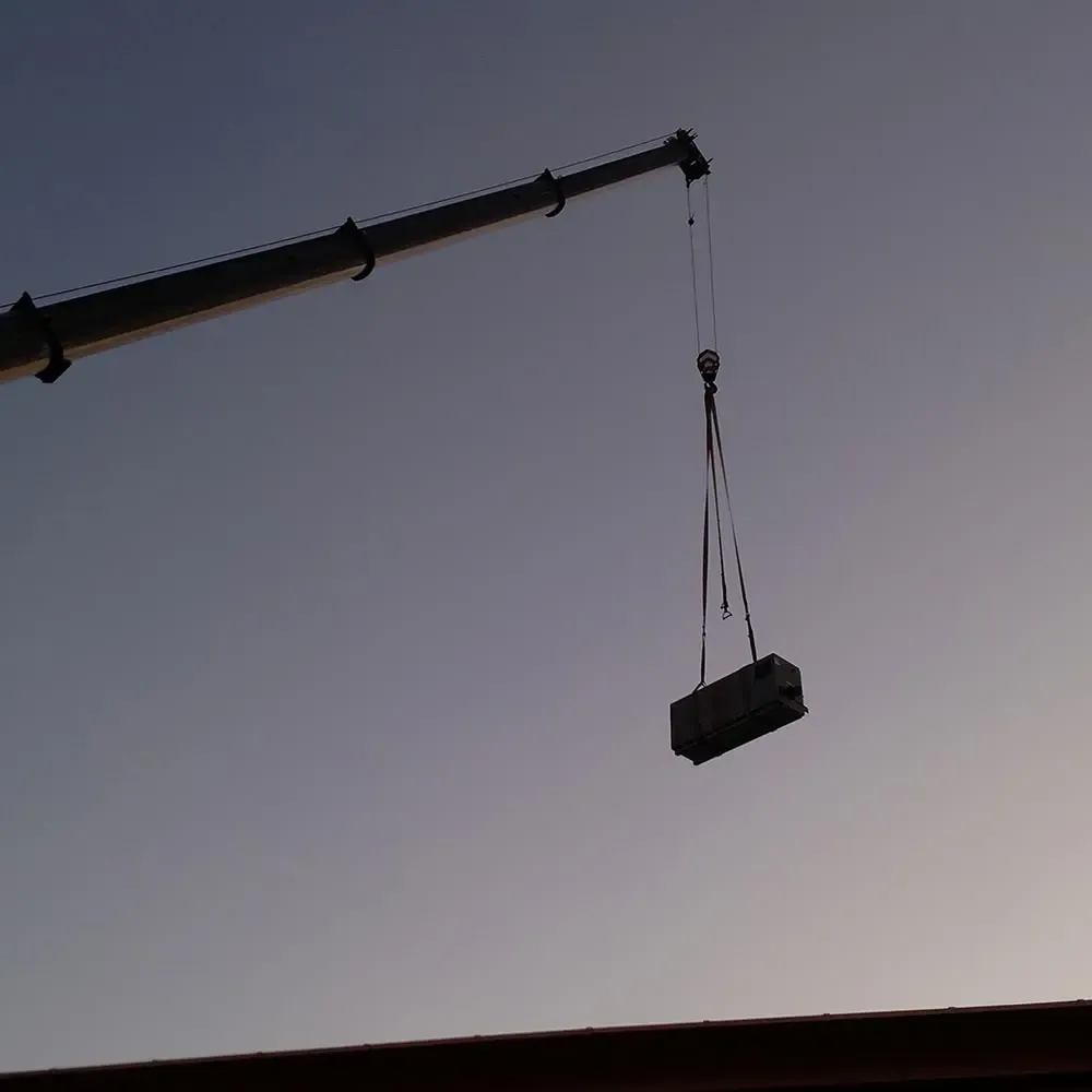 Crane lifting HVAC unit