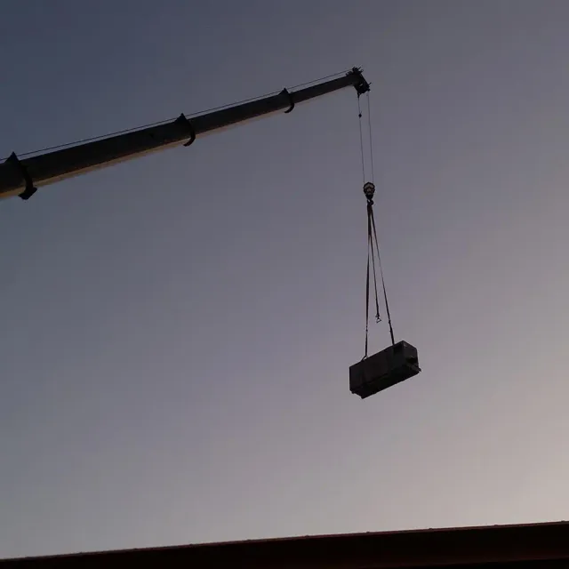 Crane lifting HVAC unit