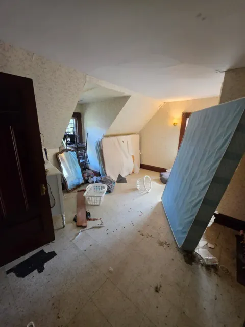 An upstairs room with an old mattress before removal