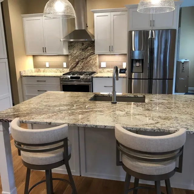 A kitchen with granite counter tops and stainless steel appliances