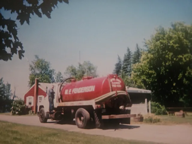 Our grandfather standing beside the W.E. Fenderson pumper truck
