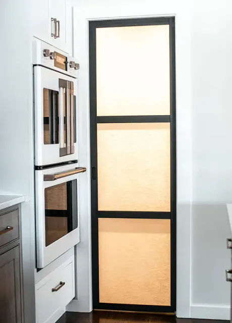 A dutch oven in a modern kitchen with white cabinets and appliances.