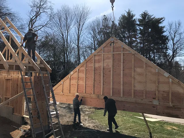 Setting truss end wall on a new garage in Hadley