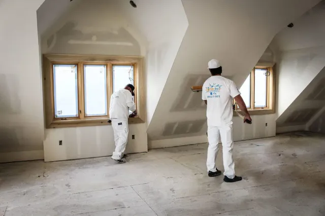 painter bros contractors painting drywall and windows of a home