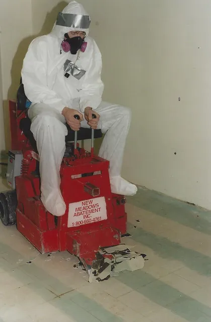 man using machine to remove asbestos flooring