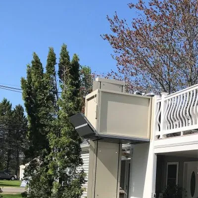 Image of vertical platform lift on side of home.