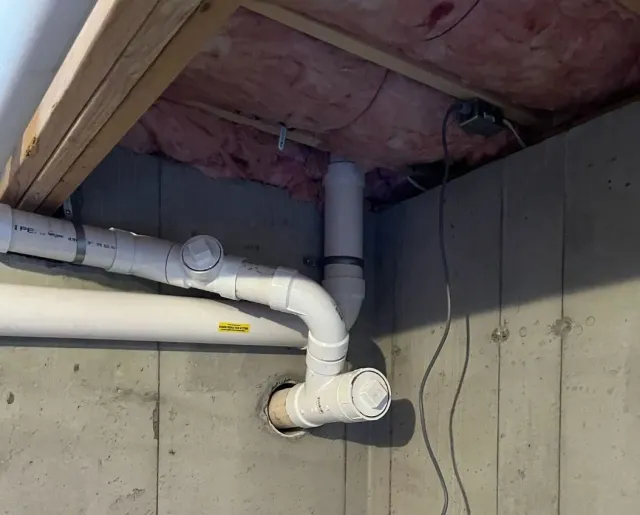 A bunch of pipes are connected to a wall