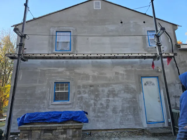 Base-coat stucco applied to a house exterior