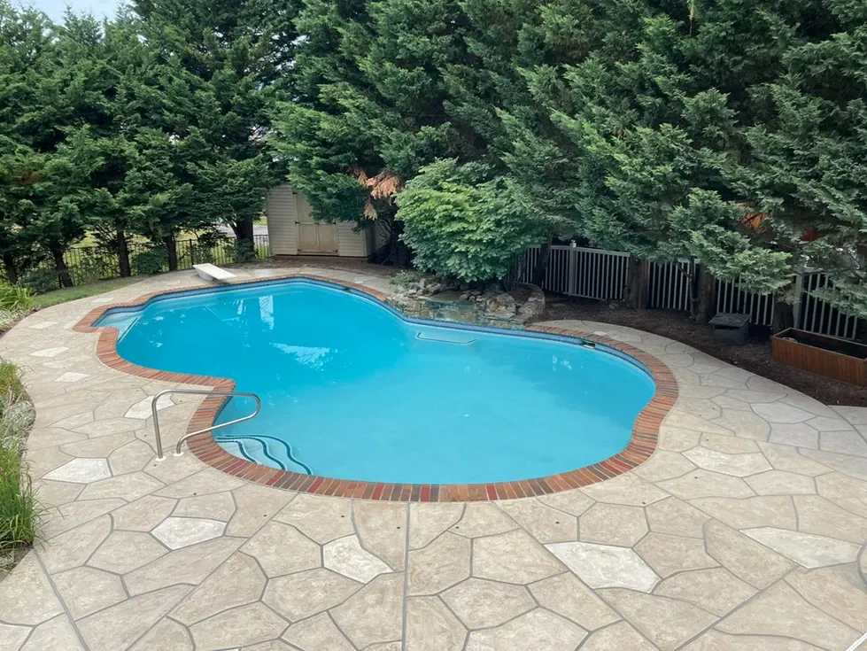 RenuKrete concrete restoration and pool deck resurfacing project featuring a sculpted flagstone design in beige and gray.