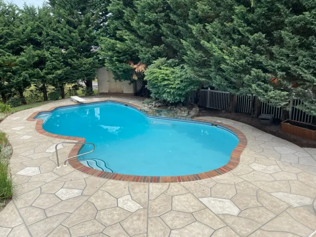 RenuKrete concrete restoration and pool deck resurfacing project featuring a sculpted flagstone design in beige and gray.