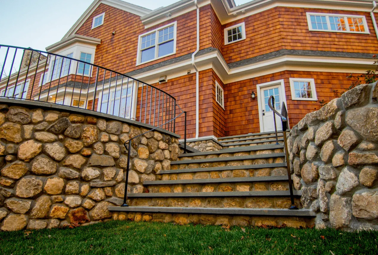 Paver patio with a fireplace, seating wall and retaining wall