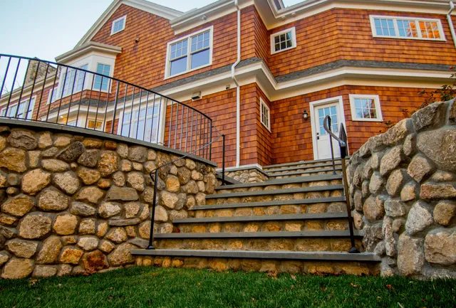 Paver patio with a fireplace, seating wall and retaining wall
