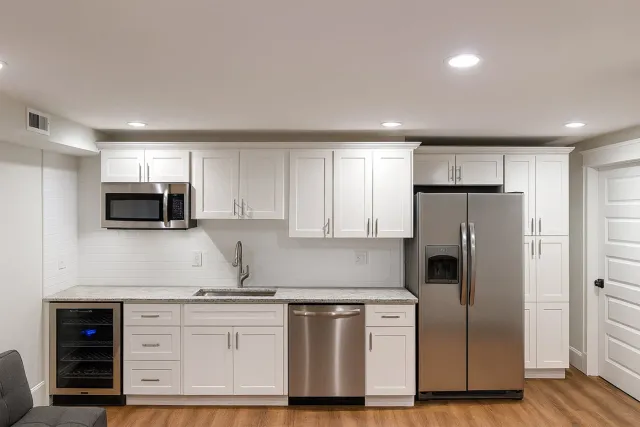 Kitchen in remodeled basement near Boston, MA by Honorato Company