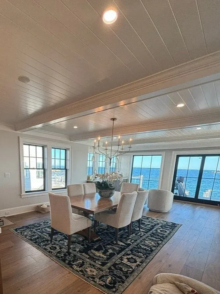 Dining room lighting installation in a coastal home