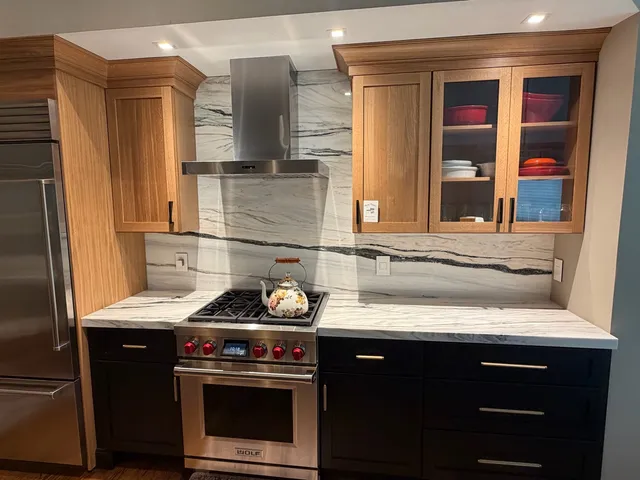 Finished countertops and full-height backsplash around a kitchen range in Marlborough, Massachusetts