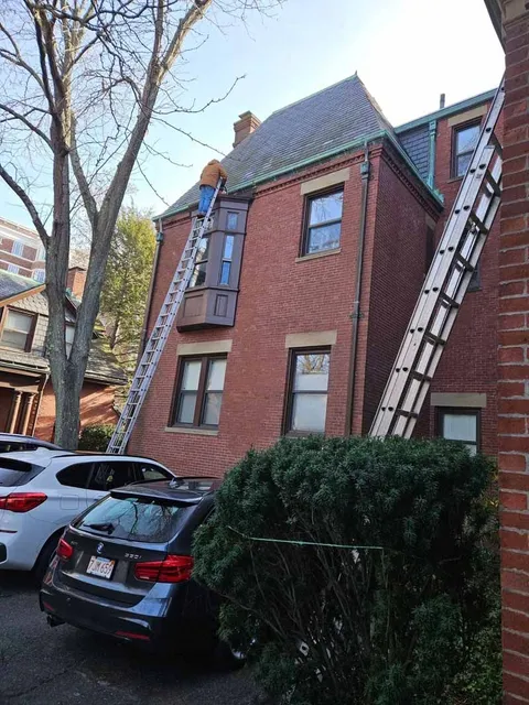 A brick building with a ladder attached to the side of it.