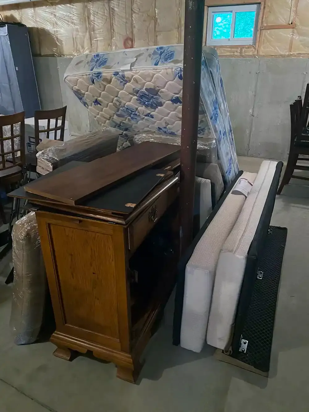 Stacked furniture items ready for a junk removal company.