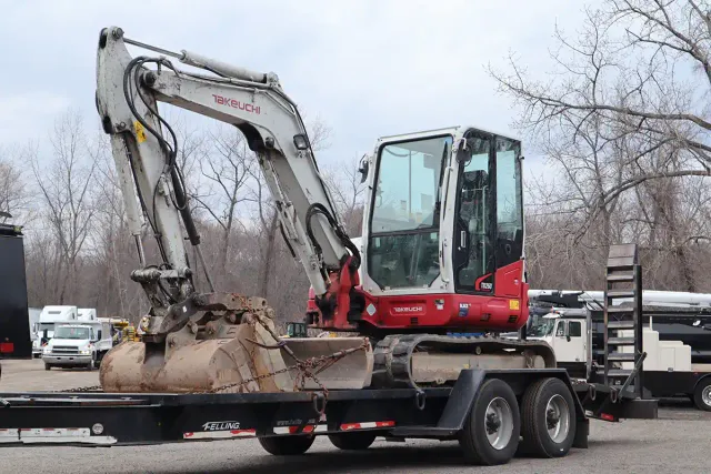 Takeuchi TB260 compact excavator on a Felling trailer — side profile view