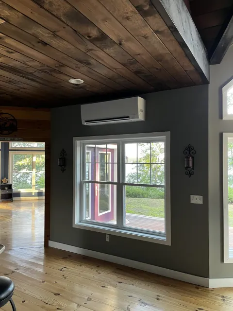 Wall-mounted head in a lakefront great room by TJM Climate Control, Southern NH & northern MA