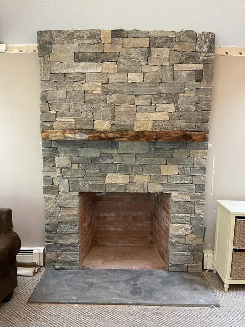 Custom chimney and natural stone veneer fireplace in Douglas Massachusetts
