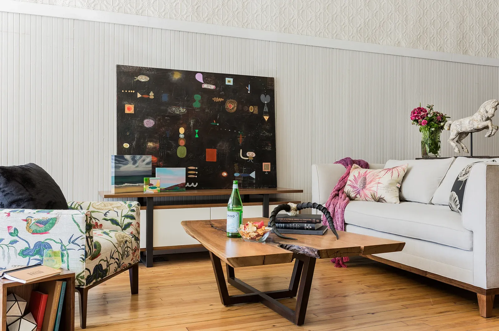 Low arm chair with printed linen,&nbsp; media cabinet in walnut with painted maple and steel,&nbsp; walnut slab coffee table,&nbsp; Half Crown sofa.&nbsp; Artwork by Stacey Alickman.