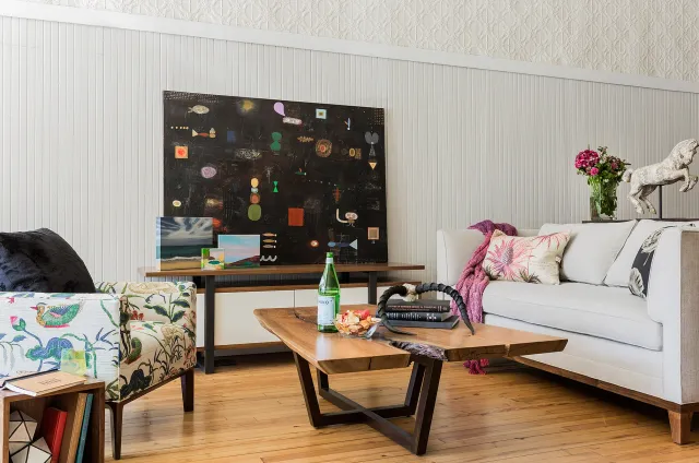 Low arm chair with printed linen,&nbsp; media cabinet in walnut with painted maple and steel,&nbsp; walnut slab coffee table,&nbsp; Half Crown sofa.&nbsp; Artwork by Stacey Alickman.