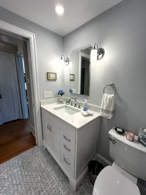 Modern bathroom vanity with sink, mirror, and lighting in a clean, bright space.