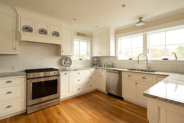 Renovated white kitchen featured alongside customer testimonial for J. Powers Construction