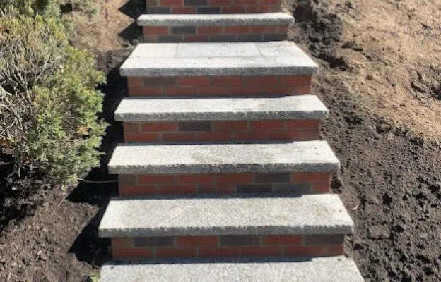 Brick and concrete steps leading up a hillside.