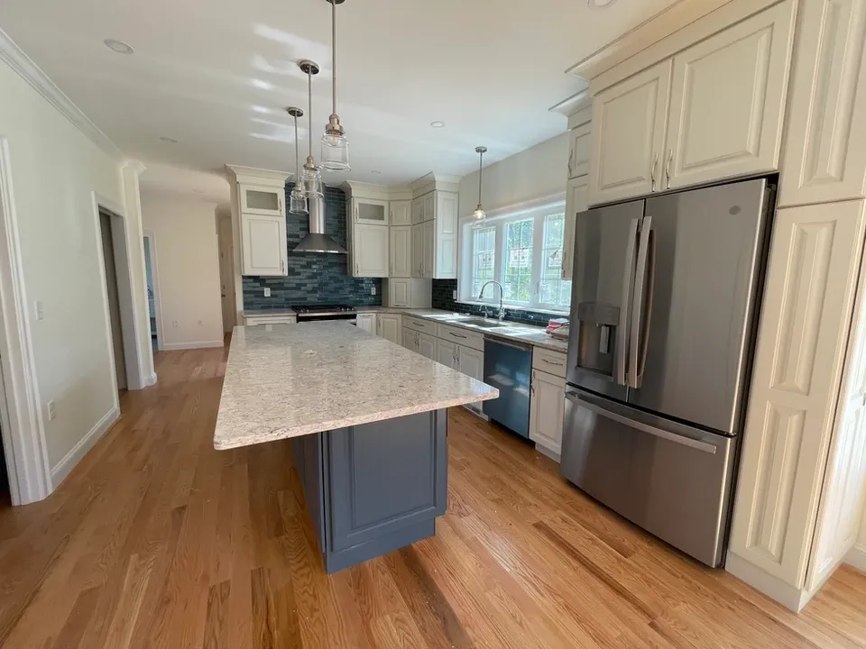 Modern kitchen with white cabinets and gray island