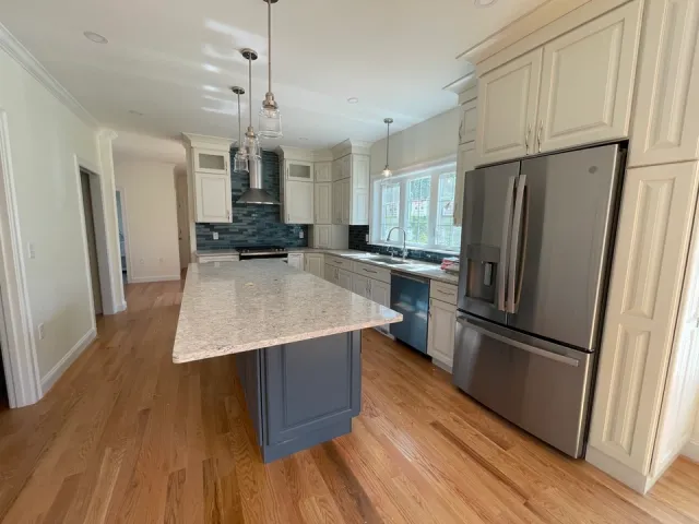 Modern kitchen with white cabinets and gray island