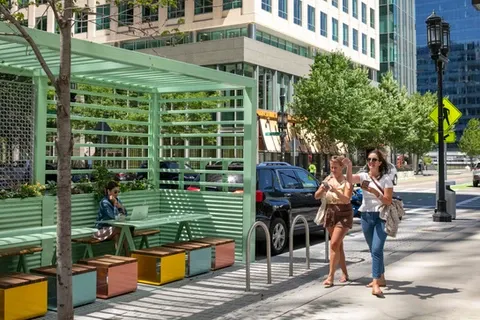People walking near the Seaport Parklet structure