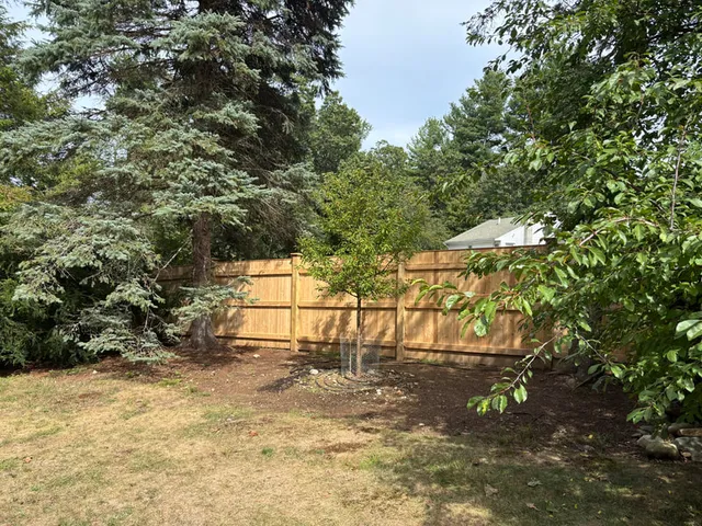 6 ft cedar board fence with cap strip and backer rails