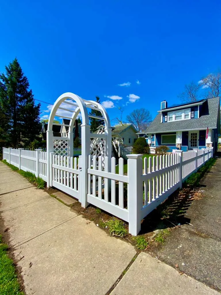 White picket fence with arbor