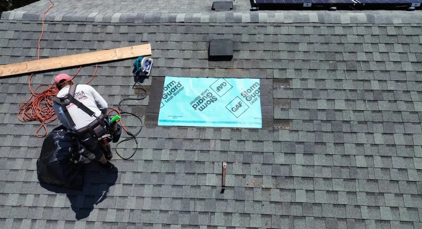 Roofer repairing roof