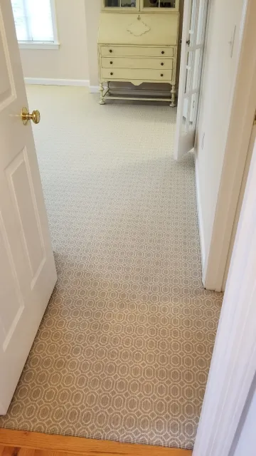 A patterned Wilton wool carpet well fitted and perfectly aligned in a master bedroom Suite.