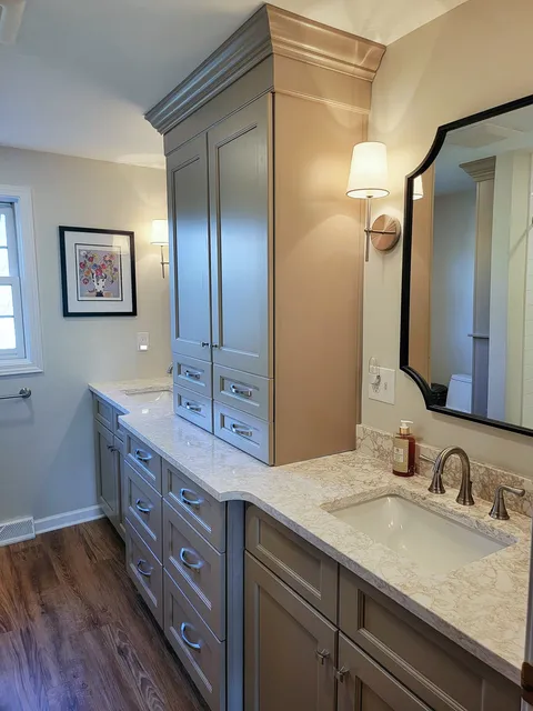 Haute Designs Kitchen & Bath. Bathroom. Double vanity and custom tall storage closet in shaker style made by Fabuwood Cabinetry painted Oyster finish. Cambria Quartz – Hermitage countertop. Brushed nickel hardware & fixtures
