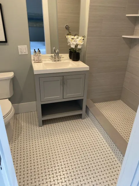 a bathroom with a sink, toilet and shower