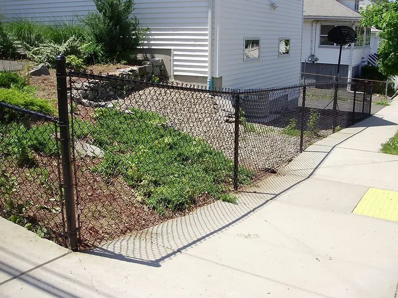 Chain link fence along a sloped yard