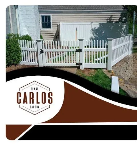 White picket fence with gate, Carlos Cadena logo in lower left.