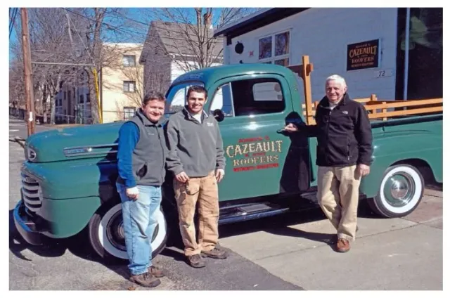 Cazeault family in front of green truck.
