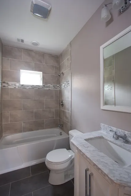 Finished bathroom with tub and vanity
