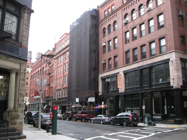 Building under construction with black safety net