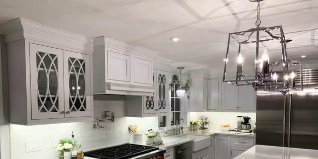 Closeup of kitchen hanging light and can lights