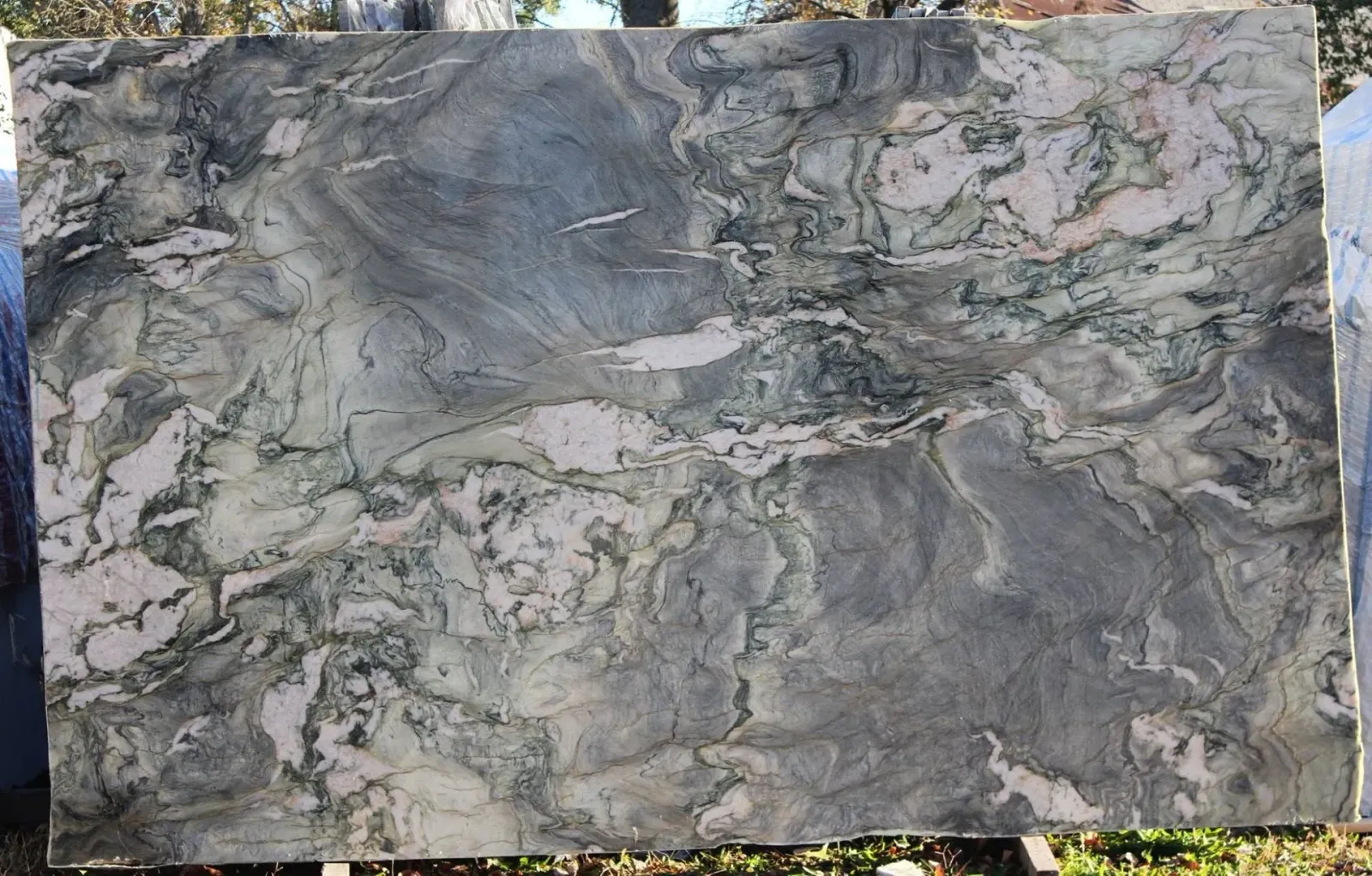 Gray and white veined marble slab with a polished, textured surface