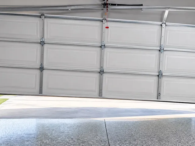 Garage door stuck crooked in the opening, off its track on one side