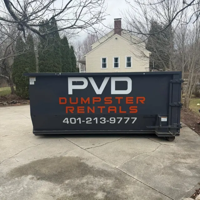 20 yard roll-off dumpster centered on a driveway