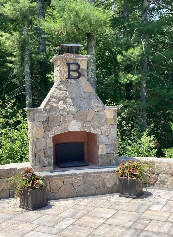 Outdoor stone fireplace with the letter