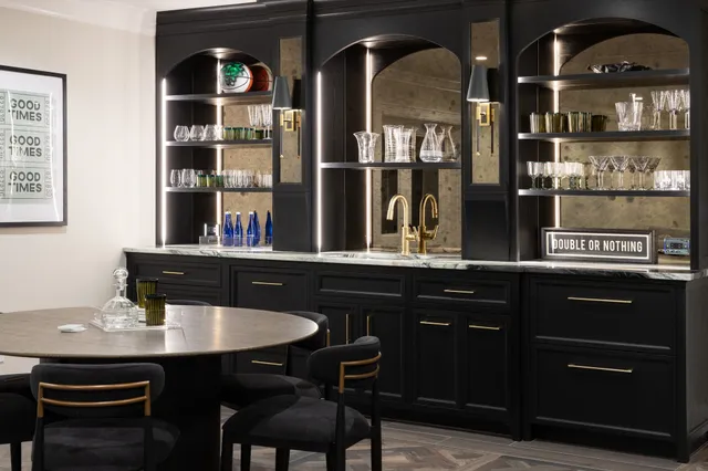Dark, architectural, and rich in detail. The custom millwork in this entertaining space combines deep black cabinetry with illuminated arched shelving and antiqued mirror panels, creating a bar that feels equal parts classic and striking.
Cabinetry: Fallon Fine Cabinetry
Interior Designer: @tastedesigninc 
Photographer: @emilyobrienphoto_design 
Architect: @slocumhalldesign 
#CustomBar #HomeBarDesign #CustomCabinetry #CustomMillwork #LuxuryMillwork #LuxuryInteriors #LuxuryHomes #EntertainingSpace #BarDesign #BuiltInBar #ArchitecturalMillwork #CabinetryDesign #InteriorDetails #BespokeInteriors #LuxuryHomeDesign #FineWoodworking #MoodyInteriors #CustomBuilder #MassachusettsBuilder #NewEnglandHomes